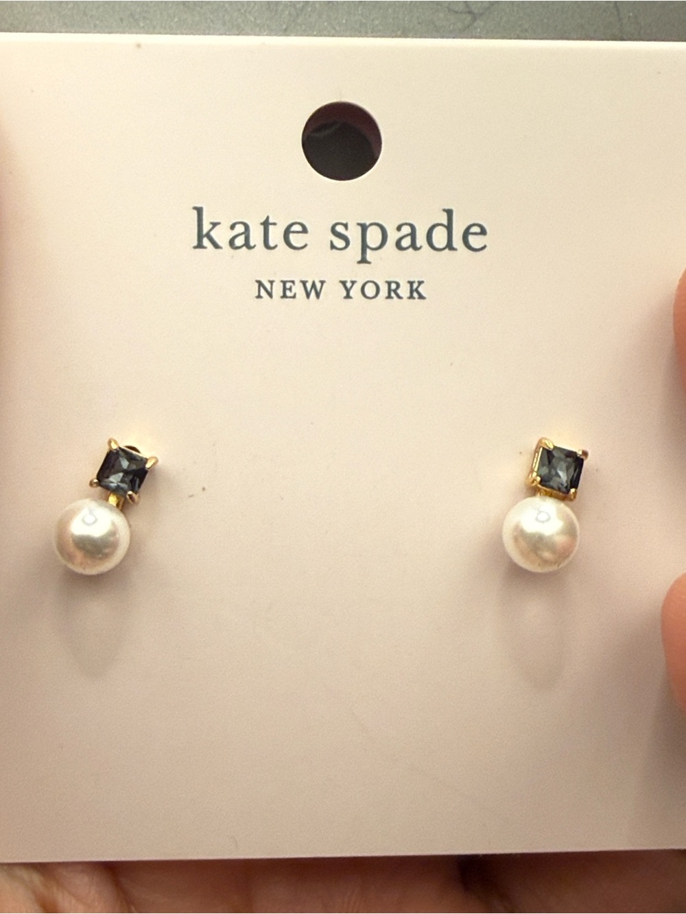 kate spade gold-tone stud earrings with clear backs on pink card